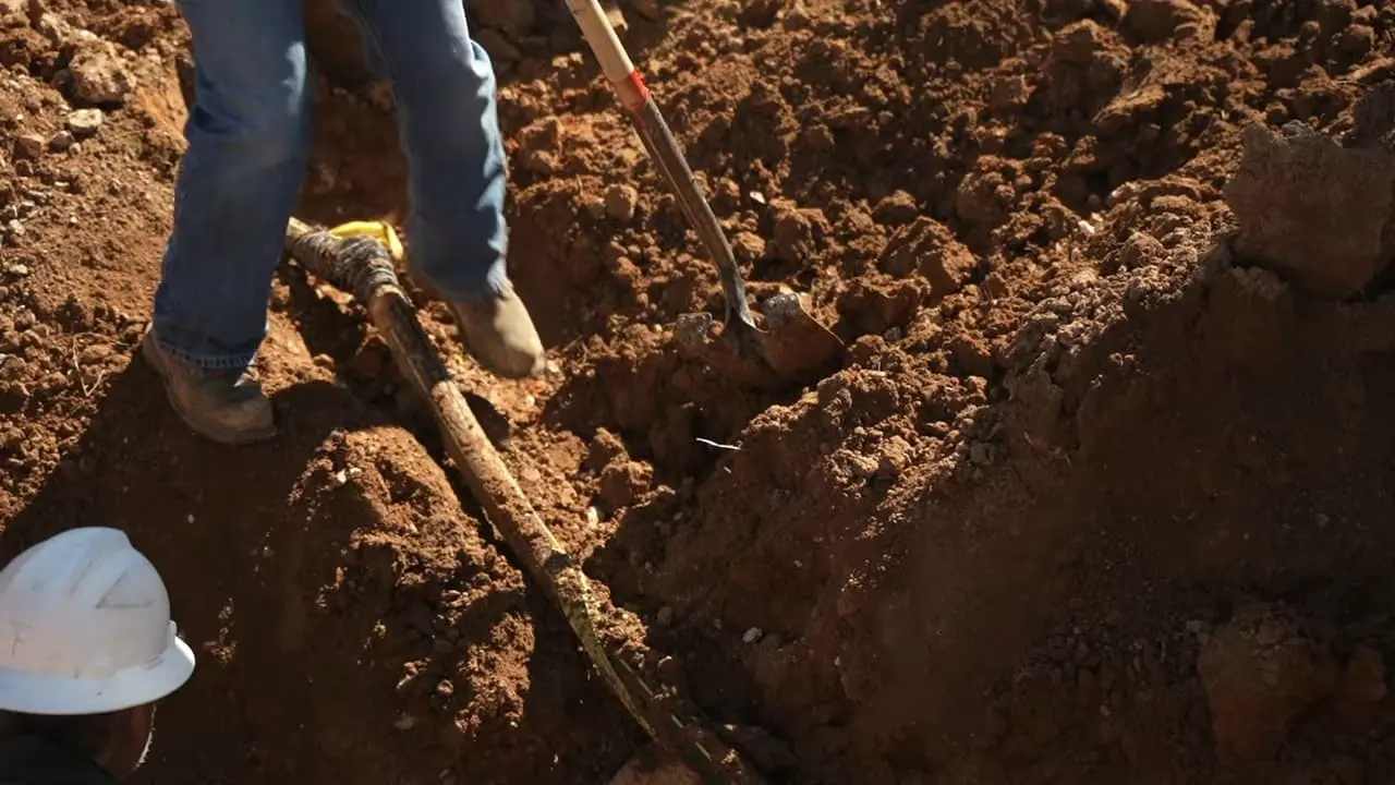 Trench dug to expose a buried gas pipe for repair at a Chicago home