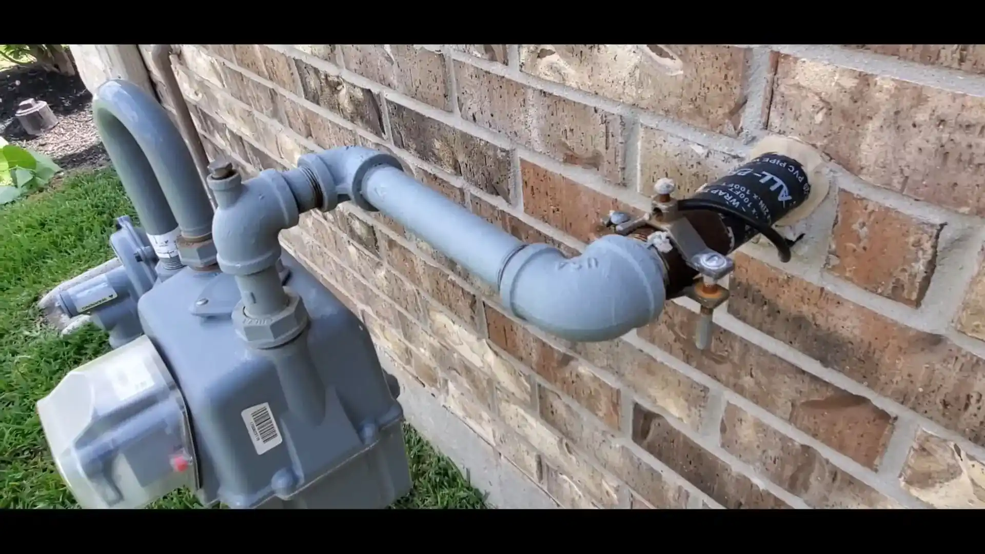 Gas line pipe repair on a brick exterior wall of a Chicago home