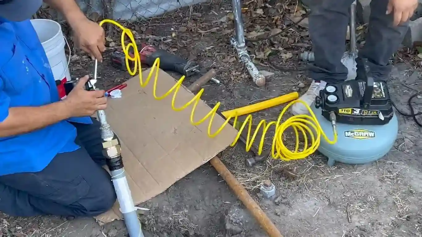 New gas line under air compressor pressure test during Chicago installation