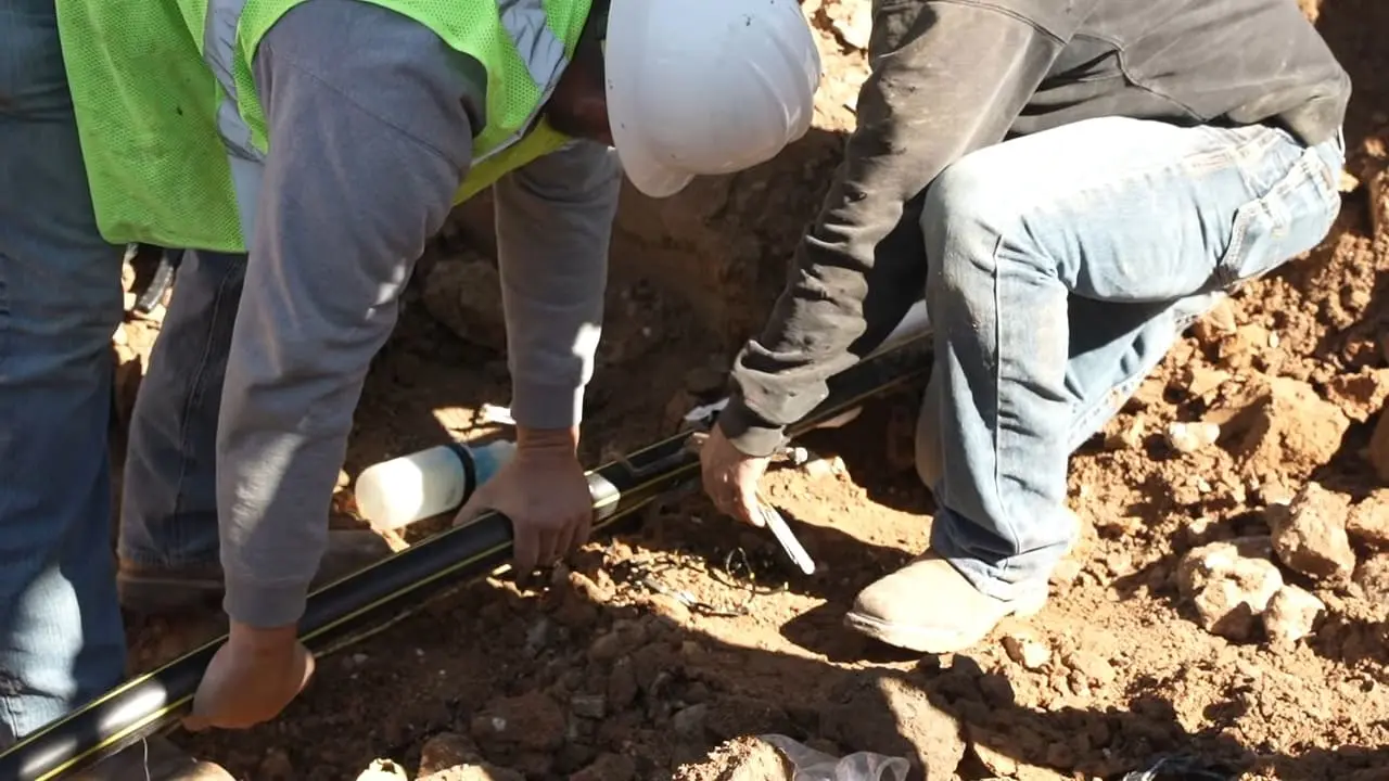 Licensed technician performing gas line repair on black iron pipe in Chicago, IL