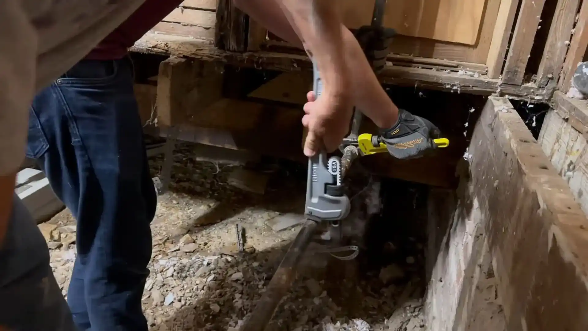Methodical gas pipe disconnection in a crawlspace during Chicago meter relocation