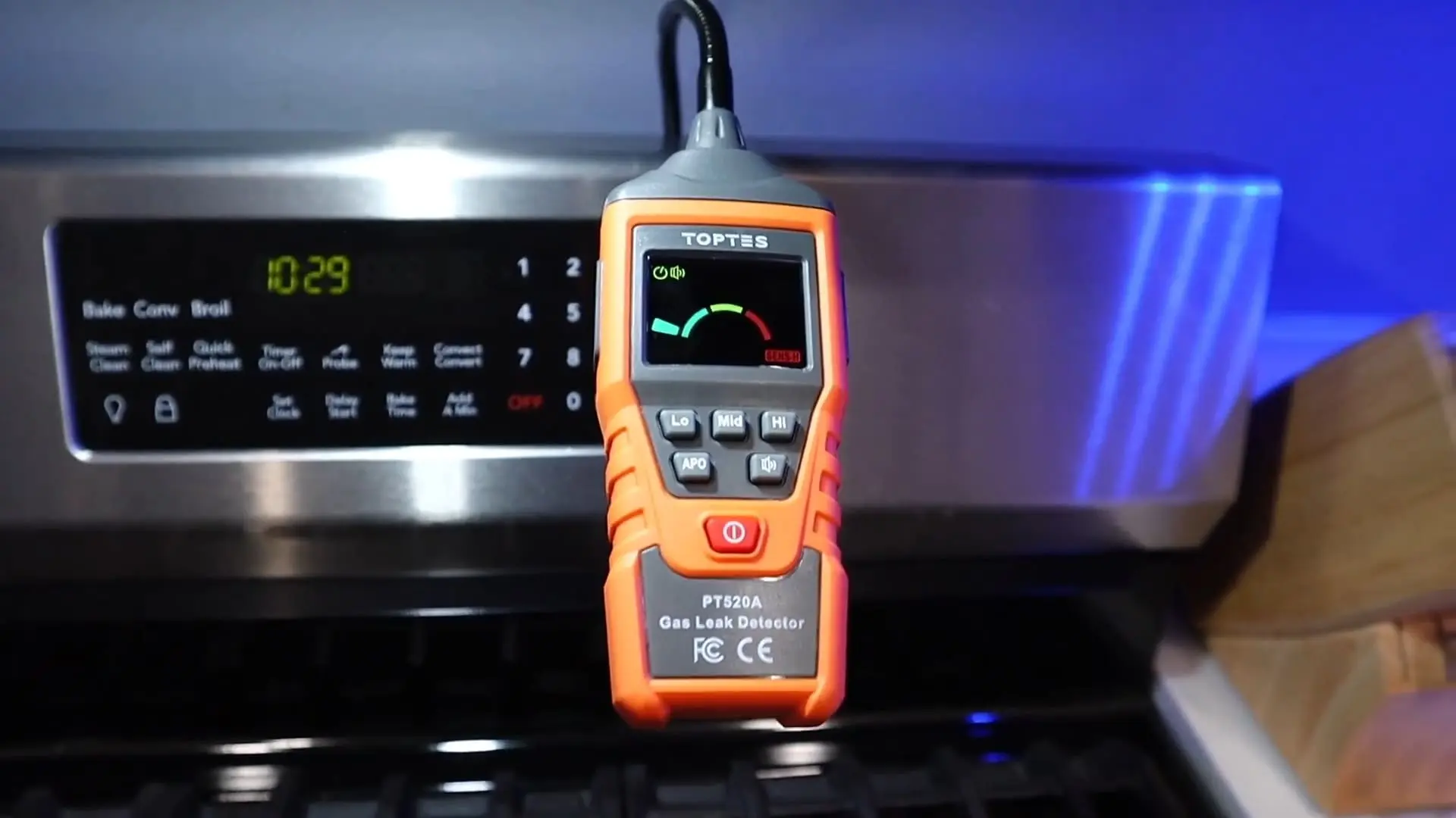 Portable gas leak detector checking a kitchen stove in a Chicago home